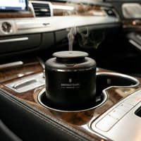 Aromatherapy diffuser in a car's cup holder with steam rising from it.