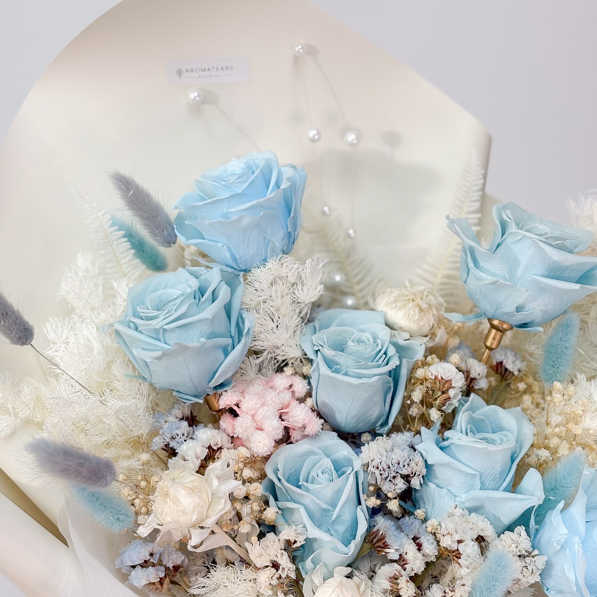 Close-up detail of premium preserved blue roses in Aromatears Vancouver signature bouquet
