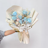 Person holding Aromatears' blue preserved rose bouquet demonstrating actual size and scale of this Vancouver florist's luxury everlasting arrangement